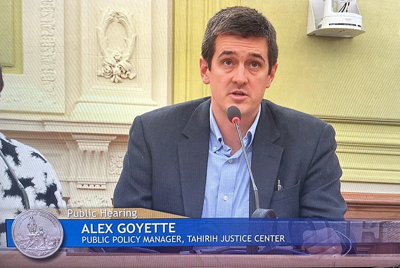 white male speaking into a microphone in a government building