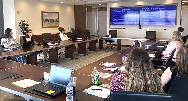 People in conference room looking at a projected screen